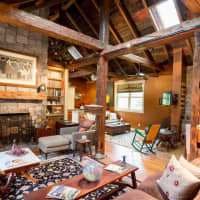 <p>The entire home features hewn beams from a barn in Canada.</p>