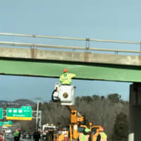 <p>Workers make repairs on the overpass.</p>