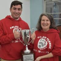 <p>Nicholas, a senior at Iona Preparatory, and Plungers moderator Patricia Gray with the Cool School Challenge trophy on December 17, 2018.</p>