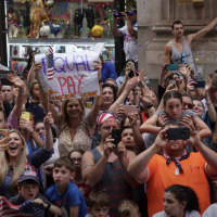 <p>A woman attending the Canyon of Heroes parade in Manhattan holds up an &quot;Equal Pay&quot; sign.</p>