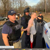<p>Michael D. Mosley being apprehended by police.</p>
