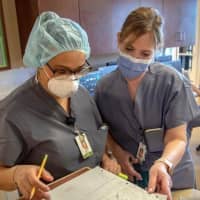 <p>Lori Van Bever, right, returns to Holy Name Hospital after battling coronavirus.</p>