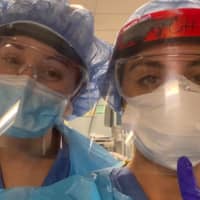 <p>Hospital workers display face shields donated by Hatteras Printing of Tinton Falls.</p>