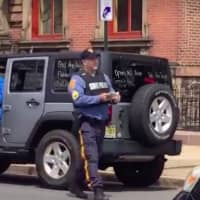 <p>A New Jersey State police officer tickets protestors Friday in Trenton.</p>