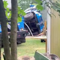 <p>Scene of a crane collapse in Tinton Falls, as captured on video by Jacques John Guire. The front wheels of the cab of the tipped-over crane can be seen in this image.</p>