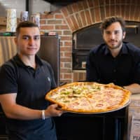<p>Hadi Parhizkaran (left) and Michael Ghinelli are opening Pizza Club in Garfield Wednesday, just seven months after opening their first location in Edgewater.</p>