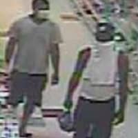 <p>Surveillance footage of the wanted man and his associate</p>
