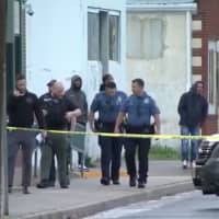 <p>Detectives investigate a fatal shooting about a block from the police station in Paulsboro. (Courtesy: 6ABC-TV News)</p>