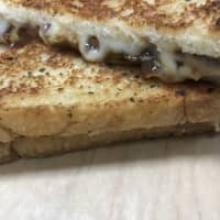 <p>The Frenchie - Grilled Cheese
Smoked Gruyere, caramelized onion braised in beef stock and rustic garlic bread, with a side of Potato chips</p>
