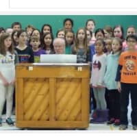 <p>Fifth graders at Dobbs Ferry Springhurst Elementary School sing for those who died in terrorists attacks in Paris, France and San Bernardino, Calif.</p>