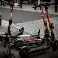 <p>Four scooters in a row with one knocked down.</p>