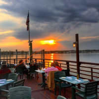 <p>Patrons linger over their meals and cocktails at the Sunset Grill in Norwalk, located on Long Island Sound at the mouth of the Norwalk River.</p>