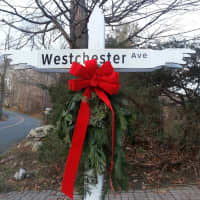 <p>The Pound Ridge Garden Club has decorated town street-sign posts with swags.</p>