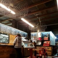 <p>TFS Burger Works&#x27; industrial decor plays up its past as a gas/service station. Its juicy burgers, however, are all-natural and made with beef from contented, grass-munching cattle.</p>