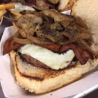 <p>You can barely see the burger for all the sauteed mushrooms, onions, bacon and Swiss cheese piled on top at TFS Burger Works in West Haverstraw.</p>