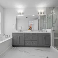 <p>Bathrooms include custom wood vanities and Kohler fixtures.</p>