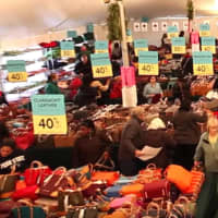 <p>Shoppers crowd the tent at last year&#x27;s sale at Dooney &amp; Bourke in Norwalk.</p>