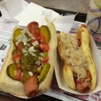 <p>A Chicago Dog, left, with pickles, tomatoes, relish and onions, and the New York Dog, with sauerkraut and red onions at The Dog House in Nanuet.</p>