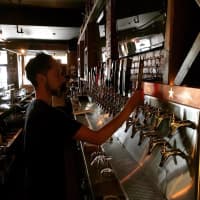 <p>A bartender downloads some microbrew from one of the 90 taps at The Shepherd &amp; The Knucklehead in Haledon.</p>