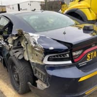 <p>A parked New York State Police car was struck by a Freightliner box truck on Tuesday, Nov. 30.</p>
