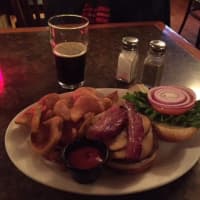 <p>The smoked gouda and slab bacon burger at Watson&#x27;s comes with a heap of Sidewinder fries.</p>