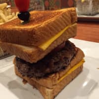 <p>It might take a fork lift to get WBC&#x27;s &quot;The Entourage&quot; to your mouth, but the effort would be worth it. The 10-ounce patty is served between two Texas toast grilled cheeses.</p>