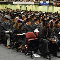 <p>White Plains High School seniors wait to graduate at commencement exercises at the County Center Saturday.</p>