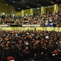 <p>Hundreds of White Plains High School students create a sea of black caps and gowns during commencement exercises at the County Center Saturday.</p>