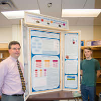 <p>Xavier Varga and Science Research Coordinator Lawrence McIntyre shown with Xavier&#x27;s presentation titled: &quot;Magnetocrystalline Anisotropy and Magnetic Properties of Gadolinium, Terbium and Dysprosium.&quot;</p>