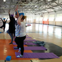 <p>Students practice yoga with instructor Jill Gettinger.</p>