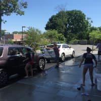 <p>Members of the Village Lutheran Church youth wash a car to help raise funds for an upcoming trip to New Orleans.</p>