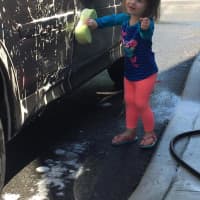 <p>A young girl lends a hand at Saturday&#x27;s carwash held by Village Lutheran Church youth group.</p>