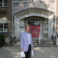 <p>George Perham stands outside his alma mater, Stratford High School.</p>