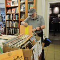 <p>A customer peruses boxes of vintage vinyl at the Friends Book Shop at the Ferguson Library in Stamford. A 50 percent off sale on all gardening and cook books runs through Aug. 6.</p>