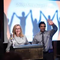 <p>Anthony Martinez, right, of White Plains joins master of ceremonies Meredith Viera in addressing supporters of Abbott House at its annual The Loving Arms Award dinner last month.</p>