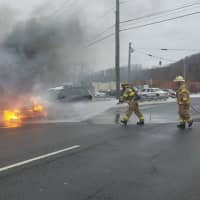 <p>A car is shown engulfed Tuesday morning in Brookfield.</p>