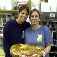 <p>Bagels on Hudson&#x27;s Owner Debbie Liaskos and her sister, Kim Peterson, who manages the eatery, hold a giant bagel sandwich that could easily serve 28 people.</p>