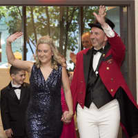 <p>Jason Julian, the Barnum Festival Ringmaster, waves to the crowd along with his wife, Tammy.</p>