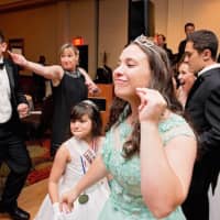 <p>A young woman gets into the groove while dancing at the ball.</p>