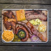 <p>A plate of barbecued entrees is shown at Hoodoo Brown BBQ in Ridgefield where platters of food can be shared family-style.</p>