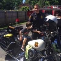 <p>Although his arms were barely long enough to reach the handlebars, one Bedford child got to find out what it feels like to sit on a police motorcycle on the town&#x27;s recent Truck Day.</p>