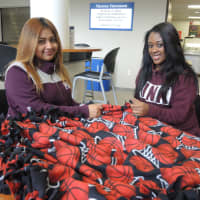 <p>Berkeley College students Eneyda de Dios of Paterson and Zoe Patterson of Elmwood Park work on blankets for Project Linus.</p>