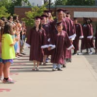 <p>Bethel High School seniors march past younger students Thursday afternoon at Frank A. Berry Elementary School.</p>