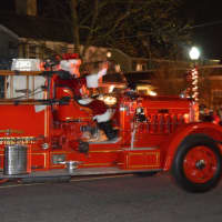 <p>Santa Claus arrives on a vintage fire truck at the Bethel tree lighting.</p>