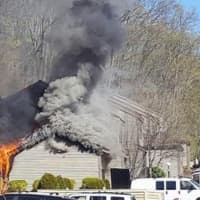 <p>Firefighters from the Bethel, Stony Hill, and Danbury departments fight a blaze at the Plumtree Heights condominum complex in Bethel Saturday. The fire displaced a family of four.</p>
