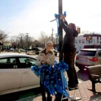 <p>People took to the streets to attach blue ribbons to the downtown for Autism Awareness Month</p>