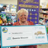 <p>Bonnie Weaver, a 61-year-old Hopewell Dutchess resident, holds a facsimile of her &quot;Royal Riches&quot; lottery winnings.</p>