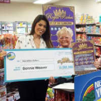 <p>Hopewell Junction resident Bonnie Weaver, right, and an unidentified woman hold a facsimile of her winnings from a $1 million &quot;Royal Riches&quot; scratch-off card.</p>