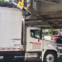 <p>The box truck hit the clearance sign on the train bridge on Friday in South Norwalk. </p>