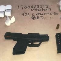 <p>Guns, drugs and cash were seized during a raid that netted nine arrests in Bridgeport.</p>